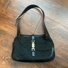 Used Vintage Jackie O Hobo In Black Gg (Cloth W/Black Leather Trim). Bag Was Purchased In 2001, Brand New. It Is Used But In Good, Wearable Condition. Buckle Does Have Some Discoloration. Comes With Dust Bag And Two Tags Shown In Pictures (However, Not Original Dustbag. This Dustbag Is A Bit Small For Bag). Gucci Hobo Bag Vintage, Gucci Shoulder Bag With Branded Hardware For Business, Gucci Business Shoulder Bag With Branded Hardware, Gucci Luxury Shoulder Bag With Gunmetal Hardware, Luxury Gucci Shoulder Bag With Gunmetal Hardware, Gucci Black Shoulder Bag For Business, Gucci Black Leather Shoulder Bag, Black Gucci Leather Shoulder Bag, Black Leather Gucci Shoulder Bag