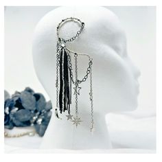 Feel and look magical when you wear this gorgeous silver tone, moon and star charm ear wrap, single  ear cuff with black chains and long tassel fringe. No piercing required. The non-pierced, single earring is one of a kind and perfect for dressing up your whimsigoth jewelry style, Halloween accessories, back to school outfits and gothic wedding gift for her. The captivating, celestial design will keep all eyes on you. Non-pierced, lightweight silver tone base loops over the ear. Fits women's, one size. No piercing required. Handmade, featuring high quality upcycled details. Sustainable shipping included plus gift-wrapping and custom orders by request. READY to SHIP. ONE SIZE No piercing required. Base loops over the ear. DETAILS 🖤 Celestial ear cuff earring. 🖤 No piercing required. 🖤 Lo Silver Dangle Ear Cuff For Party, Nickel-free Silver Cartilage Earrings For Party, Silver Metal Ear Climbers, Silver Metal Ear Climbers For Party, Gothic Star-shaped Party Jewelry, Silver Nickel-free Ear Cuff For Parties, Silver Dangle Ear Cuff As Gift, Adjustable Silver Whimsical Ear Cuff, Whimsical Adjustable Silver Ear Cuff