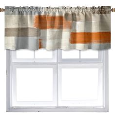 an orange and white curtain hanging on a window