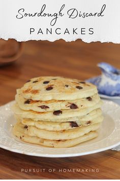 a stack of pancakes sitting on top of a white plate