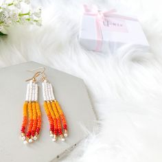 Beautiful White & multicolor hand-beaded earrings. These pairs of rainbow tassel earrings are the perfect earrings for you or for that special gift that you are looking for. They are made with high-quality seed beads and gold-plated ear wires, so if you like them, choose your variation and add click Add to cart and we will prepare them for you. You will receive one pair of earrings available in 2 options: sunset and purple sunset.  Item description:   Materials: -Seed beads in size 11/0 -Gold pl Summer Gift Rainbow Earrings, Trendy Rainbow Earrings For Summer, Rainbow Dangle Earrings For Summer, Elegant Summer Jewelry With Dangling Beads, Summer Rainbow Jewelry With Dangling Beads, Trendy White Round Beaded Earrings, Trendy White Round Bead Earrings, Trendy Beaded Summer Jewelry, Trendy Summer Jewelry With Matching Earrings