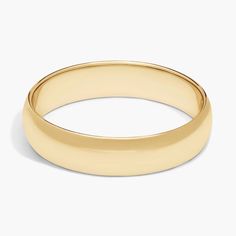 a yellow gold wedding ring on a white background