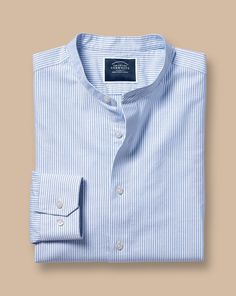 100% cotton, Available in slim fit, Collarless, Mitred button cuff with two buttons, Oxford Weave, Mid-weight, Split back yoke, Machine washable - Collarless Stretch Washed Oxford Stripe Shirt - Ocean Blue | Men's Charles Tyrwhitt Collarless Stretch Washed Oxford Stripe Casual Shirt - Ocean Blue Single Cuff Size Large Cotton Slim Fit Cotton Shirt With Button Cuffs, Relaxed Fit Cotton Dress Shirt With Buttons, Slim Fit Cotton Top With Buttons, Slim Fit Cotton Top With Fold Down Collar, Cotton Slim Fit Top With Fold Down Collar, Cotton Tops With Slim Fit And Fold Down Collar, Casual Slim Fit Top With Fold Down Collar, Summer Cotton Shirt With Fold Down Collar, Unstructured Buttoned Tops For Spring