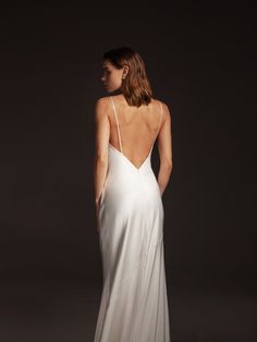 a woman in a white dress is looking back