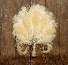 a bridal bouquet with white feathers and crystal beads on a wooden surface, ready to be used as a centerpiece