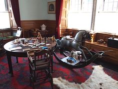 an old fashioned rocking horse is in the middle of a living room