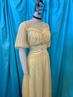 "1930s/1940s W:28 yellow sheer rayon short puff sleeve illusion neckline star sequin braid trim runched shelf bust drop waist party dress. THIS FEATURES * Yellow sheer rayon mesh like base * Full yellow fille acetate lining * Short puff sleeves * Elastic sleeve hem * Illusion crew neck * Sequin star details * Braid trim detailing * Sweetheart runched bust * Shelf bust design * Fitted waist * Drop waist design * Button up back closure * Self covered buttons/loops * Gathered skirt waist * A-line s Fitted Yellow Vintage Dress With Short Sleeves, Yellow Fitted Vintage Dress With Short Sleeves, Yellow Fitted Short Sleeve Vintage Dress, Fitted Yellow Vintage Dress For Party, Yellow Fitted Vintage Dress For Parties, Drop Sleeve Dress, Prairie Fashion, Thirties Fashion, Vintage 40s Dress