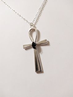 "◆ Pendant with Ankh cross The pendant measures 2.16535 x 1.1811 inches and it is silver plated, a beautiful black teardrop crystal is set in the center. the size of the chain is adjustable but for any need you can contact me :) The product is handmade with great care. ♡ In my shop there are many handmade jewels for all tastes, come and look at them you are welcome! ♡ -------------------------------------------------------------------------- The Ankh cross is perfect to wear around the neck and Black Cross Jewelry With Adjustable Chain, Silver Cross Necklace With Adjustable Chain, Black Ankh Metal Jewelry, Ankh Shaped Black Metal Necklace, Silver Ankh Gothic Necklace, Black Ankh Necklace In Metal, Silver Spiritual Cross Necklace With Adjustable Chain, Black Metal Cross Jewelry, Spiritual Silver Cross Necklace With Adjustable Chain