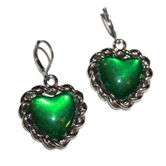 "Green Chain Heart Earrings - these measure 1.75\" long including the hooks. They are a tad heavy, so best not for super sensitive ears. I have sensitive ears and I could wear them for an event, but not a full day. The hooks are extra secure and will work with gauges. I love this color green. It has the look of a mood ring but it does not change colors." Green Heart Charm Earrings For Valentine's Day, Metal Heart Earrings With Heart Beads, Green Heart Shaped Earrings For Parties, Green Heart-shaped Earrings For Valentine's Day, Trendy Nickel-free Heart-shaped Jewelry, Green Heart-shaped Jewelry For Party, Trendy Dangle Heart Earrings With Ear Wire, Green Double Heart Jewelry For Valentine's Day, Green Heart-shaped Party Jewelry