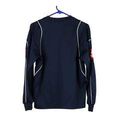 a navy sweatshirt with white piping and red letters on the chest, hanging from a hanger