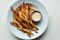 french fries on a plate with dipping sauce