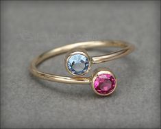 This gorgeous ring is made using two manmade gemstones or synthetic opals, that have been set in tube bezels. This ring is slightly adjustable. Handcrafted from 14k gold-filled. Please refer to photo for birthstone and opal color choices. • sold individually• 14k gold-filled, manmade gemstones, synthetic opal• stones: 4mm• band width: 1.3mm Don't know your ring size? Purchase a Reusable Ring Sizer *This is a made to order item. Please check the announcement at the top of the page for current pro Diamond Birthstone Ring, Dual Birthstone Ring, Cute Promise Rings, Mother's Ring, Birthstone Ring Mothers, Mothers Ring, Colored Stone Rings, Synthetic Opal, Opal Color