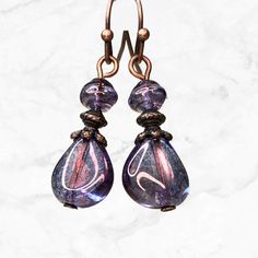 Purple iridescent teardrop beads with a soft luster and hints of blue pair up with copper accents in these beautiful Czech glass earrings.  Exceptional beads for everyday wear or dress up.  Lightweight earrings are easy to wear all day. Best seller.  Hypoallergenic ear wires (nickel and lead free). Choose ear wire style at checkout. Longer version: https://www.etsy.com/listing/1349683659/purple-long-earrings-purple-copper Also available in GREEN: https://www.etsy.com/listing/1331047177/green-woo Iridescent Drop Earrings For Jewelry Making, Iridescent Drop Earrings For Gift, Iridescent Teardrop Earrings For Gift, Purple Teardrop Beaded Earrings, Iridescent Pearl Drop Dangle Earrings, Purple Teardrop Pearl Drop Earrings, Elegant Iridescent Teardrop Earrings, Iridescent Round Beads Earrings With Ear Wire, Iridescent Beaded Drop Earrings