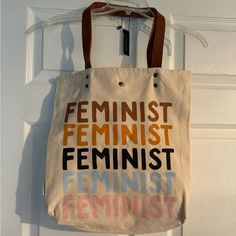 Brand New Feminist Idlewild Co Shoulder Tote Bag With Inside Pocket And Magnetic Snap Closure. Brand New With Tag Attached. Measurements Pictured. Bin 1 Beige Canvas Bag For Everyday Use, Retro Cream Bag For Daily Use, Retro Beige Tote Bag, Retro Beige Canvas Tote Bag, Trendy Beige Bag With Snap Closure, Cream Canvas Shoulder Bag With Dust Bag, Beige Canvas Bag With Dust Bag For Everyday Use, Retro Beige Pouch Bag, Spring Bags For Daily Use With Snap Closure