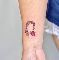 a woman's arm with a tattoo on it that has a rose in the center