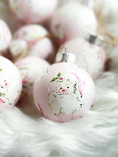 some pink and white ornaments are laying on fur