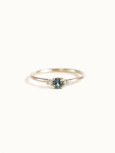 A classic teal blue green three-stone Sapphire ring with diamond accents. Dainty Wedding Ring Green, Blue Green Ring, Simple Unique Engagement Rings Silver, Small Vintage Engagement Rings, Boho Wedding Rings, Sapphire Ring Simple, Green Gem Ring, Small Engagement Ring, Mens Engagement Rings