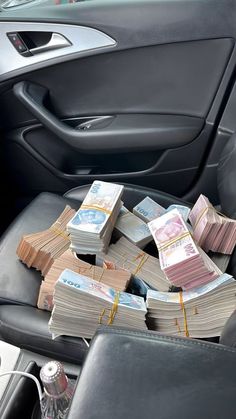 stacks of money sitting in the center console of a car