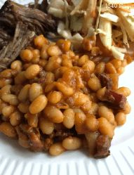 a white plate topped with beans and meat