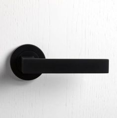 a black handle on a white door