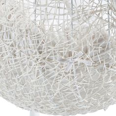 a large white basket that is hanging from the ceiling with ribbon on it's side