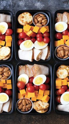 four plastic trays filled with different types of food on top of each other,