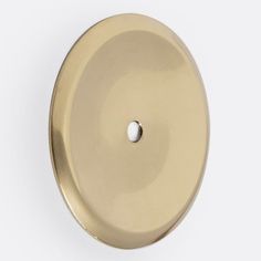 an image of a round brass knob on a white background