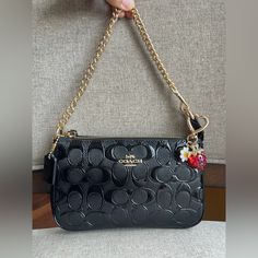 Coach Nolita 19 In Signature Leather (Coach Cv419) Colorgold/Black | Signature Patent Leather | Two Credit Card Slots | Zip-Top Closure, Fabric Lining | Chain Handle With 6 1/4" Drop | 7 1/2" (L) X 4 1/2" (H) X 2" (W)|Style No. Cv419| Designer Handbags Black, Coach Bags Black, Pinterest Apartment, Coach Nolita 19, Coach Nolita, Nolita 19, Black Coach Bag, Xoxo Jewelry, Black Coach Purse