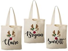 three personalized christmas tote bags with reindeer antlers and name on the front