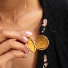 The Story A striking antique piece from the Victorian era. Created in 14 karat yellow gold, a raised mythical lion's head is the main feature of this round locket. Formed with lots of expression, two small rubies are set as the eyes with a 0.10 carat Old Mine Cut diamond set within the lion's mouth. The locket shows its age in the best possible way with the rich patina making the raised work pop and gold glow. At 1.66" tall with its bale, it's a substantial size. It holds two round photos and is Gold Medallion Locket Necklace Stamped 14k, Luxury Antique Gold Round Jewelry, Antique Gold Round Jewelry With Coin Pendant, Ceremonial 14k Gold Round Pendant Jewelry, Victorian Round Locket Necklace Stamped 14k, Ceremonial 14k Gold Stamped Medallion Jewelry, Ceremonial 14k Gold Medallion Jewelry, Ceremonial Yellow Gold Coin Jewelry, Ceremonial Yellow Gold Round Pendant Jewelry