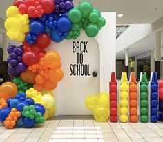 an entrance decorated with balloons and streamers for back to school