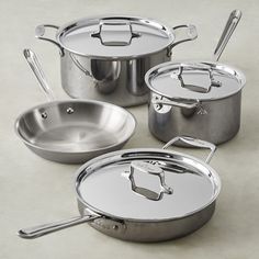 an assortment of pots and pans with lids