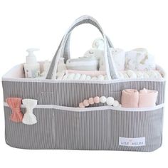 a large gray and white striped bag with baby items in the bottom section, on a white background