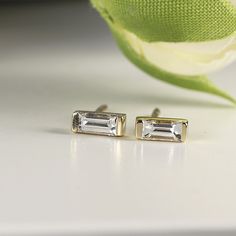 14k Gold baguette diamond stud earrings. DETAILS ABOUT THE EARRINGS ***14k solid gold settings ***Baguette Diamond size 4x2mm 0.07ct each ***Total carat weight 0.14 ctw *** Diamonds are HG color , VS clarity scale. Diamond is a stone that truly states, “I love you” in a deep way, it is symbol of deep, everlasting love. A diamond is forever. Diamond is birthstone for April. You can purchase single or pair, please choose from drop down menu. ----------------------------------- FOLLOW ME HERE: Inst Modern Baguette Cut White Diamond Earrings, Modern White Baguette Cut Diamond Earrings, Elegant 14k Gold Diamond Earrings With Baguette Diamonds, Fine Jewelry Baguette Cut Diamond Earrings, Modern White Baguette Cut Earrings, Yellow Gold Baguette Cut Diamond Earrings For Anniversary, Modern Diamond White Baguette Cut Earrings, Emerald Cut Baguette Diamond Anniversary Earrings, Emerald Cut Baguette Diamond Earrings For Anniversary