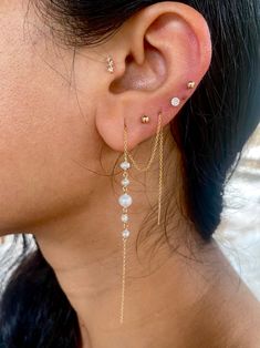 Pearls have been highly prized for all of history - it's said that Krishna plucked the first pearl from the ocean for his daughter to wear on her wedding. These pearls check all the boxes. They're modern, minimalist, classic, but also so beautiful that they'll take your breath away. These earrings are available in two styles - the standard extra long threader, and the double terminated threader. The standard threader has one end totally open and dangling, the other end threading through one or m Elegant Earrings With Satellite Chain As Gift, Elegant Earrings With Satellite Chain For Gift, Classic Dangle Jewelry With Pearl Chain, Yellow Gold Satellite Chain Jewelry For Wedding, Classic Dangle Threader Earrings, White Pearl Threader Earrings With Charm, Wedding Threader Earrings With Adjustable Chain, Minimalist Wedding Threader Earrings With Pearl Charm, Wedding Adjustable Chain Threader Earrings