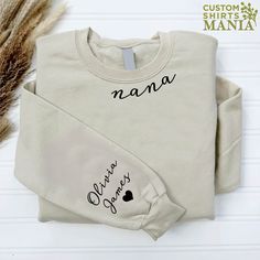 a t - shirt with the word mama written on it next to some dry grass