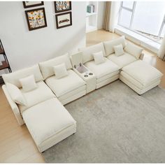 a living room with a large white sectional couch