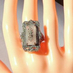 "This Gorgeous, Vintage, Camphor Glass, Diamond Ring is in Excellent condition; no scratches, no chips or cracks, no dings or dents, and no signs of repair. The face of this Beauty is 1\" long and 3/4\" wide, and it has an approximate weight of 8.6 grams. The Sterling Silver Filigree work is exquisite, the frosted glass beautiful, and it has a prong set Diamond in the center. It is set with a 3/4\" x 5/16\" Genuine Camphor Glass. It is a size 8, resizable by your local silver smith, if need be." Glass Ring, Deco Ring, Sterling Silver Filigree, Glass Rings, Art Deco Ring, Silver Filigree, Victorian Style, Ring Sterling Silver, Frosted Glass