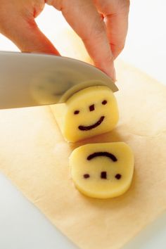 someone cutting up some smiley faces with a knife