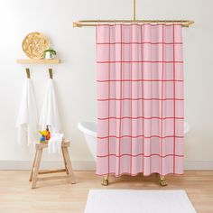 a white bath tub sitting next to a pink shower curtain