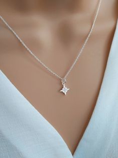 North star necklace sterling silver, Polaris starburst necklace, celestial star jewelry, silver cz diamond star necklace Shine bright with our gorgeous North Star necklace!  Handcrafted with care using a tiny sterling silver & cubic zirconia North Star charm and delicate sterling silver chain, this dainty necklace symbolises hope and inspiration.  The North Star is the anchor of the northern sky, giving guidance and direction to those who follow it. Stunning little cubic zirconia crystals mimic Elegant Silver Jewelry With Star Charm, Silver Star-shaped Diamond Necklace, Sterling Silver Star-shaped Clavicle Chain, Sterling Silver Star Necklace In Silver, Sterling Silver Star Clavicle Chain, Elegant Silver Star Of David Necklace, Celestial Star-shaped Silver Jewelry, Silver Diamond Star Necklace, Elegant Silver Star Charm Necklaces