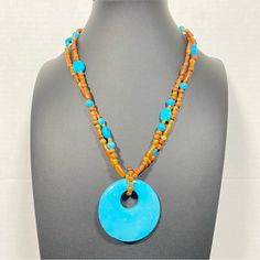 Item Offered Is A Beautiful Necklace. This Necklace Consists Of A Round Doughnut-Shaped Turquoise Focal Piece Beaded Along A Wooden And Turquoise Bead Chain. The Stones Are Absolutely Magnificent! This Piece Will Surely Turn Heads Approximate Measurements: Necklace Length: 19” And Has Extender Turquoise Focal Piece Size: 2” X 2" Color May Appear Slight Different In Person Than In Photo Due To Lighting. Colorful Beads Turquoise Necklace For Beach, Blue Wooden Beads Round Jewelry, Wooden Beads Round Necklace For Beach, Blue Wooden Round Beads Jewelry, Blue Wooden Beaded Round Jewelry, Beach Turquoise Necklace With Round Beads, Round Beach Jewelry With Large Beads, Beach Jewelry With Large Round Beads, Blue Gemstone Beads Jewelry For Beach