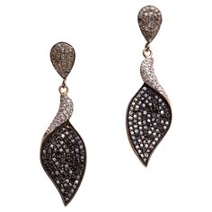 A pair of dangle earrings comprised of black and white diamonds. All are round, brilliant cut diamonds in a pave` setting. Set in sterling silver with an 18K gold post for pierced ears. The fine jewelry collection is sourced, designed or created by Deborah Lockhart Phillips. Through her international travels, she has cultivated prime resources for fine precious and semi-precious gemstones of unusual cuts in a variety of settings. Included in the collection are antique, high 22K gold pieces with intricate workmanship rarely found in the modern age. In creating the contemporary collection, Deborah works directly with artists and craftsmen to bring cutting edge jewelry designs directly to market. Diamonds to Lapis Lazuli, Emeralds to Pearls, and everything in between. Diverse, lovely and vers Pave Setting, Fine Jewelry Collection, Gold Drop Earrings, Precious Gemstones, 22k Gold, White Diamonds, Pierced Ears, Brilliant Cut Diamond, Jewelry Designs