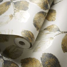 a wallpaper with yellow and gray flowers on it's side, next to a roll of tape