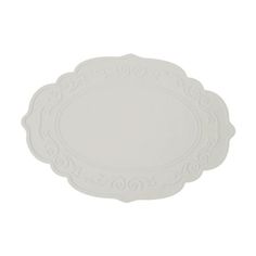 a white plate on a white background with an ornate design in the shape of a flower