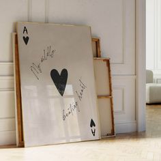 an art piece with playing cards written on it in front of a white wall and floor