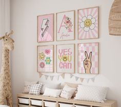 a child's room decorated in pink and white with pictures on the wall above