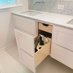 an open drawer in the middle of a kitchen counter