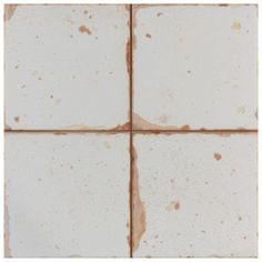 the tile is white with brown spots on it's edges and has been stained off