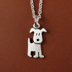 "This adorable little puppy is made of sterling silver.  The pendant is TINY, measuring about 1/2\" tall (1.3 cm).  So cute! You can purchase just the pendant/charm, or complete the necklace with a sterling silver chain.  Matching earrings:  www.etsy.com/listing/617260650/tiny-puppy-earrings © Stick Man Creations This is our own original design, handcrafted by us, and signed on the back with our logo.   For more information about the creative process, click here:  www.etsy.com/shop/StickManJewel Playful Silver Charm Necklaces, Playful Silver Necklaces With Charms, Cute Sterling Silver Pendant Charm Necklaces, Cute Sterling Silver Pendant Charm Necklace, Cute Silver Pendant Charm Necklace, Handmade Cute Sterling Silver Charm Necklaces, Cute Nickel-free Sterling Silver Necklaces, Cute Silver Sterling Silver Charm Necklaces, Small Sterling Silver Charm Necklace